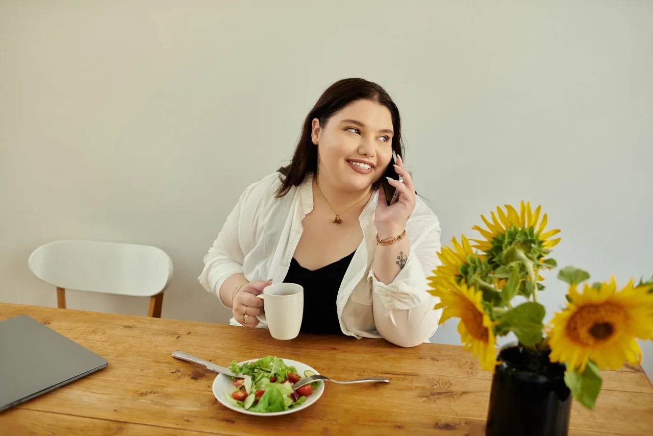 A cheerful woman connects with someone while savoring her meal at home. Brunch, Food, Head